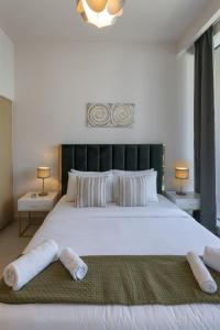 a bedroom with a large white bed with two pillows at Harbour Gate 1 - 2BR Apartment - Allsopp&Allsopp in Dubai