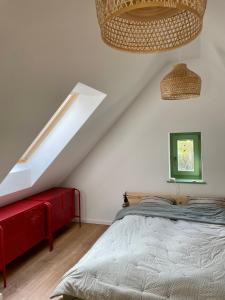 a bedroom with a bed and a red bench at Pince a hegyen in Szentantalfa
