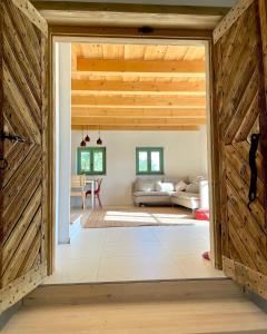 a barn door opens up to a living room at Pince a hegyen in Szentantalfa