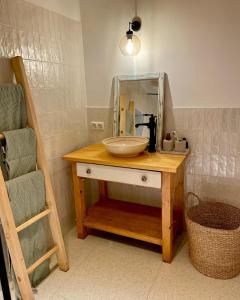 a wooden table with a sink and a mirror at Pince a hegyen in Szentantalfa +22 photos