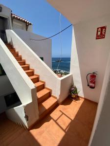 a staircase in a house with a view of the ocean at Cosy twin beds El Galeon in Santa Cruz de Tenerife