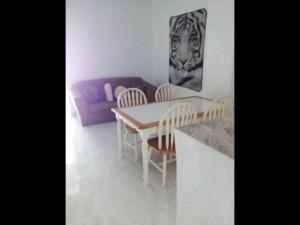 a living room with a table and chairs and a couch at Appart hotel Veras Samana No 8 in Santa Bárbara de Samaná