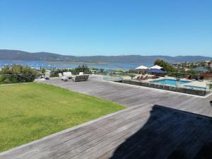 a large deck with a view of the water at Issaquena Heights Boutique Hotel in Knysna