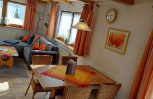 a living room with a table and a couch at Haberjockelshof in Titisee-Neustadt