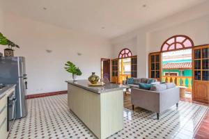 a kitchen with an island in a living room at 2cm-B1 Apartment In Getsemani With Air Conditioning Pool And WIFI in Cartagena de Indias