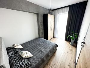 a bedroom with a bed with two pillows on it at ApartLoft 64 Apartament Zator in Zator