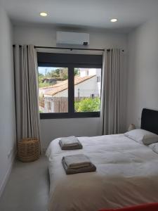 a bedroom with a large bed with towels on it at Luxury Top Villa Alhambra Pool close to Sea and Centre in Benalmádena