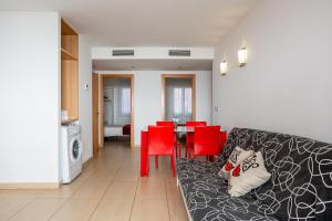 a living room with a couch and red chairs at S23 Sa Caleta in Lloret de Mar
