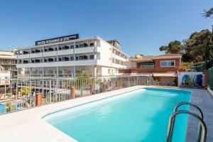 a swimming pool in front of a hotel at S23 Sa Caleta in Lloret de Mar