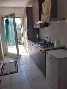 a kitchen with a sink and a stove top oven at La Casina in Passignano sul Trasimeno