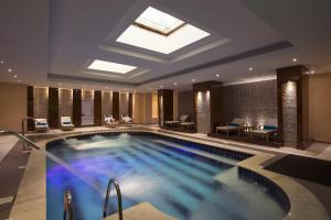 a large swimming pool in a hotel room at Sunrise Arabian Beach Resort in Sharm El Sheikh
