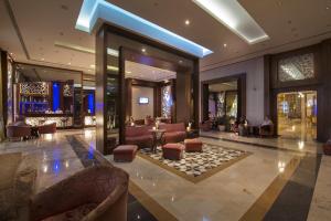 a lobby with couches and a bar in a building at Sunrise Arabian Beach Resort in Sharm El Sheikh