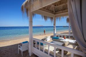 a view of the beach from the porch of a beach house at Sunrise Arabian Beach Resort in Sharm El Sheikh