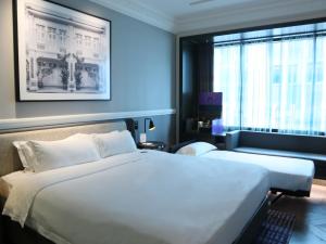 a hotel room with a large bed and a window at Grand Park City Hall in Singapore