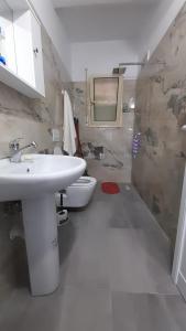 a bathroom with a sink and a toilet at Halilaj apartament in Vlorë