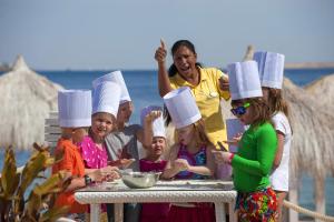 a group of people wearing chefs hats on a table at Sunrise Arabian Beach Resort in Sharm El Sheikh