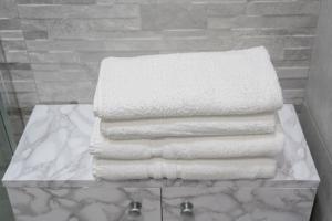a stack of towels on a table in a bathroom at LA CHICCA DI CAROLA in Bari +32 photos