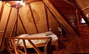 a small room with a bed in a cabin at Chalet Etno Oaza near Airport in Sarajevo