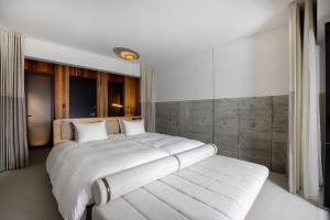 a bedroom with a large white bed with white pillows at Izumo HOTEL THE CLIFF 