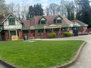 a building with a green lawn in front of it at Commuters Getaway in Chesterfield