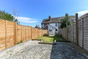 a wooden fence in front of a house at The Colebrook in Royal Tunbridge Wells