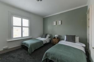 a bedroom with two beds and a window at The Colebrook in Royal Tunbridge Wells
