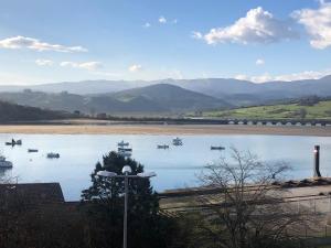a view of a river with boats on it at Vistas de La Barquera in San Vicente de la Barquera