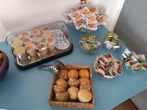 a blue table with a tray of food and snacks at Alice Hotel in Cervia