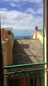a balcony with a view of the ocean from a building at Lola a Moneglia in Moneglia