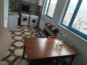 a dining room with a table and a kitchen at Apartment for good feelings in Sevan