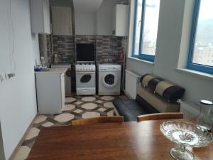 a kitchen with a table and a kitchen with a washing machine at Apartment for good feelings in Sevan