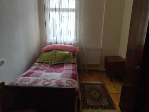 a small bedroom with a bed and a window at Apartment for good feelings in Sevan