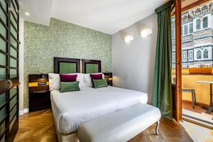 Postel nebo postele na pokoji v ubytování Hotel Duomo Firenze