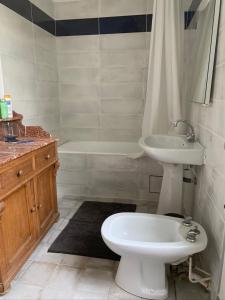 a bathroom with a sink and a toilet and a bath tub at Moulin de Battereau - Jardin & Verger - 9km d'Amboise in Saint-Martin-le-Beau