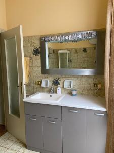 a bathroom with a white sink and a mirror at Lola a Moneglia in Moneglia