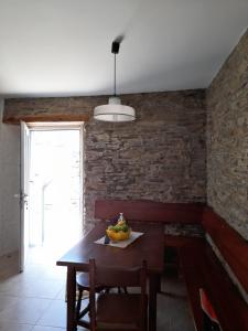 a dining room with a table with a bowl of fruit on it at Apartamento Playa de Esteiro in Ribadeo