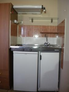 a kitchen with a stove and a sink at Chios Rooms MyView in Karfas