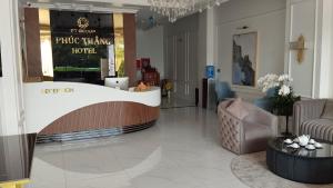 a lobby with a reception desk in a building at Phúc Thắng Hotel in Phú Quốc