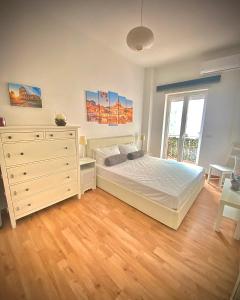 a bedroom with a bed and a dresser and a window at I-LARI Apartment in Rome