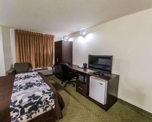 a hotel room with a bed and a flat screen tv at Sleep Inn Morganton Southeast in Morganton