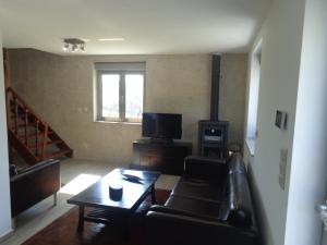 a living room with a couch and a table at Casa da Lagoa in Alvarães