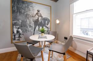 a dining room with a table and chairs and a painting at Turpin Quarter in the centre of the city, sleeps 6 in York