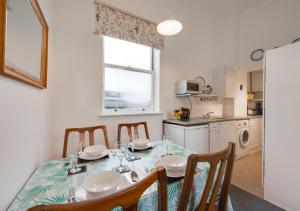 een keuken en eetkamer met een tafel en stoelen bij Kemp Town Mews in Brighton & Hove