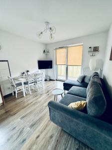 a living room with a couch and a table at AL-Dom Apartamenty Apartament Anioł in Kołobrzeg
