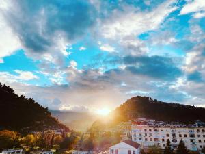 a view of the sun setting behind a mountain at Hotel Republika Berat in Berat