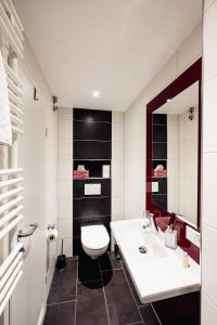 a bathroom with a white toilet and a sink at Hotel Busche am Dom in Münster