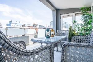a patio with chairs and a table on a balcony at Gorgeous Flat with Balcony in Besiktas in Istanbul
