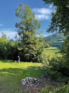 a man standing in a field with a tree at Einhornhaus in Schottwien