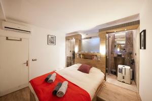 a bedroom with a red and white bed and a shower at Cannes Flat Rentals in Cannes