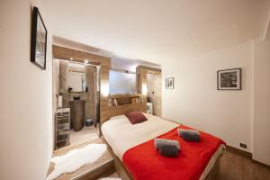 a bedroom with a large bed with a red blanket at Cannes Flat Rentals in Cannes